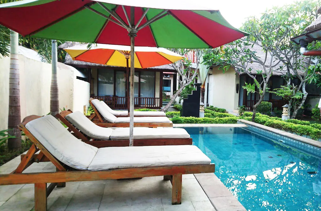 Poolside loungers under colorful umbrellas at Joje Hotel